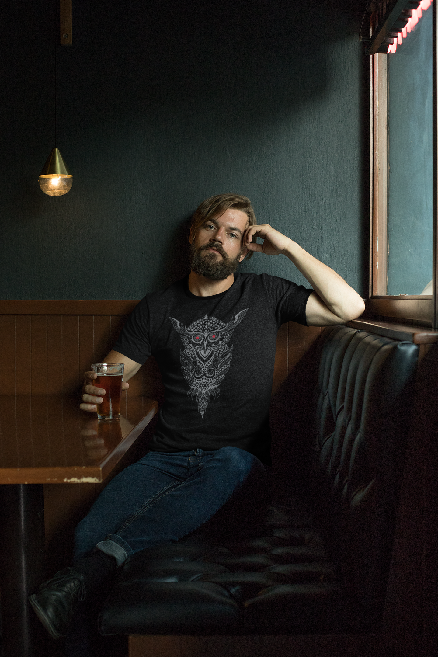 mockup-of-a-bearded-man-wearing-a-ringer-heathered-t-shirt-sitting-on-a-restaurant-couch-27928.png