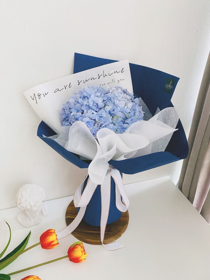 Blue hydrangea bouquet with modern wrapping