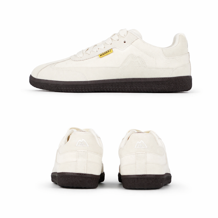 Minimalist cream sneakers in studio shot