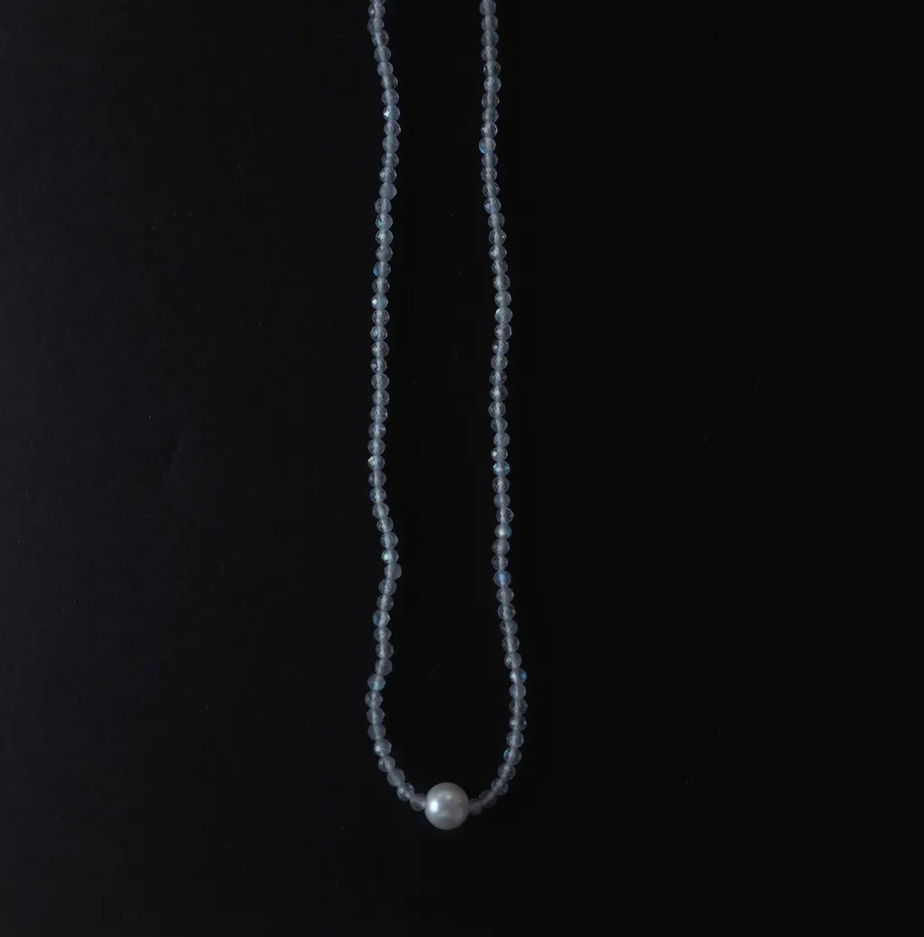 Celia極細拉長石項鍊，在深色背景中，盡顯簡優雅光澤