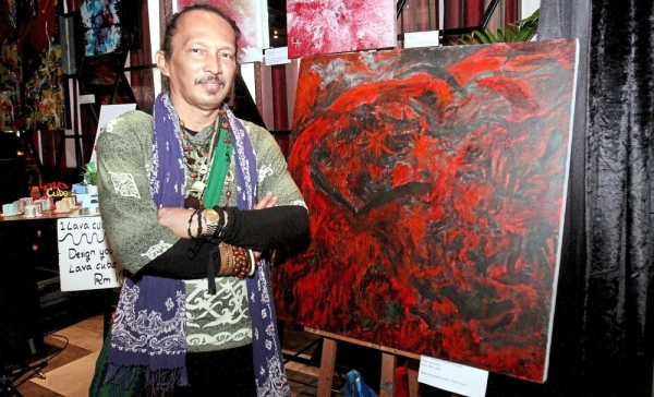 Ayawan in front of his creation, ‘Dark Soul’.