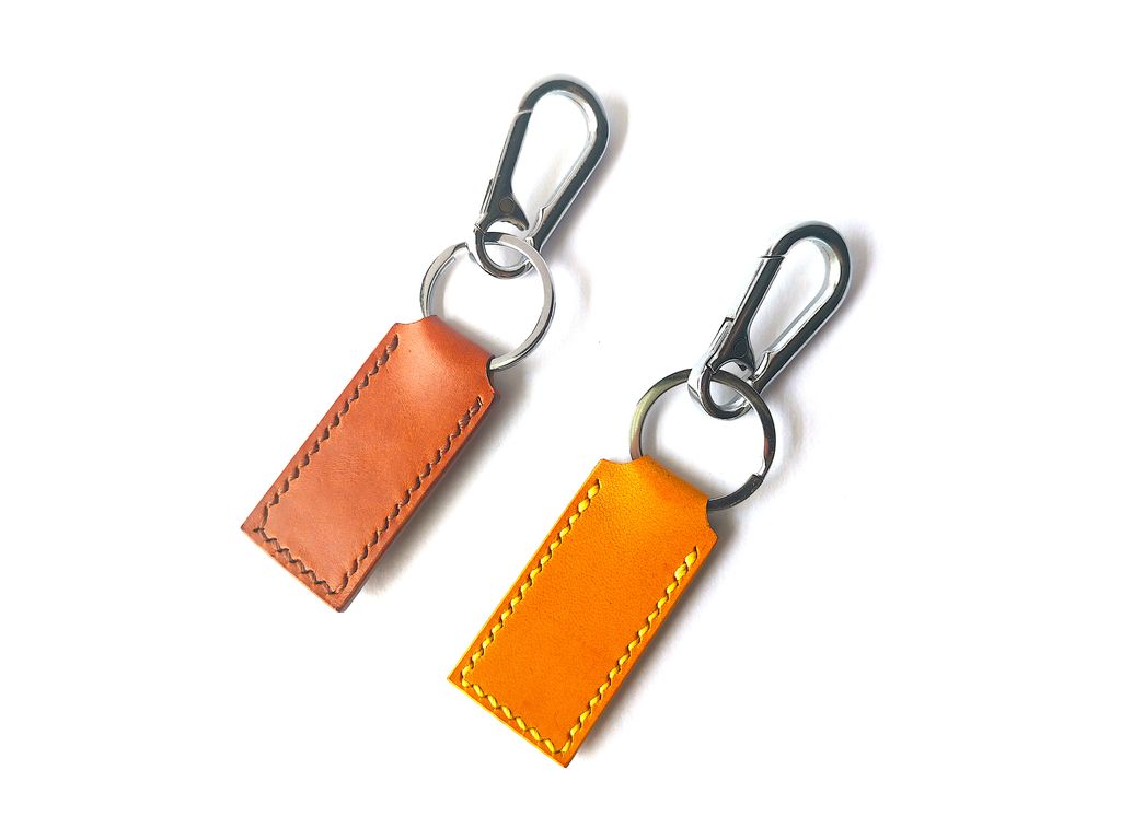 brown and yellow buttero key chain