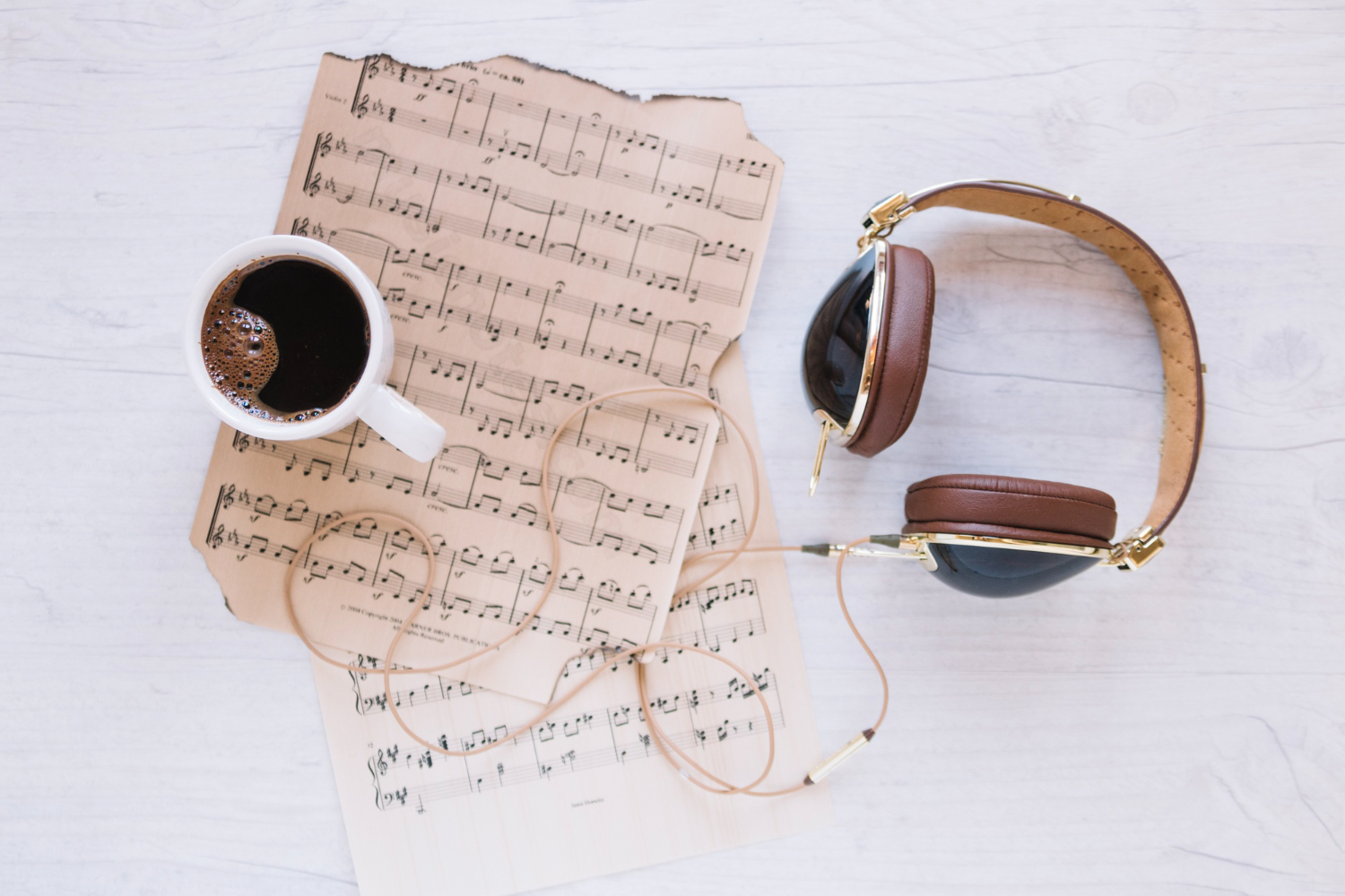 headphones-coffee-near-sheet-music