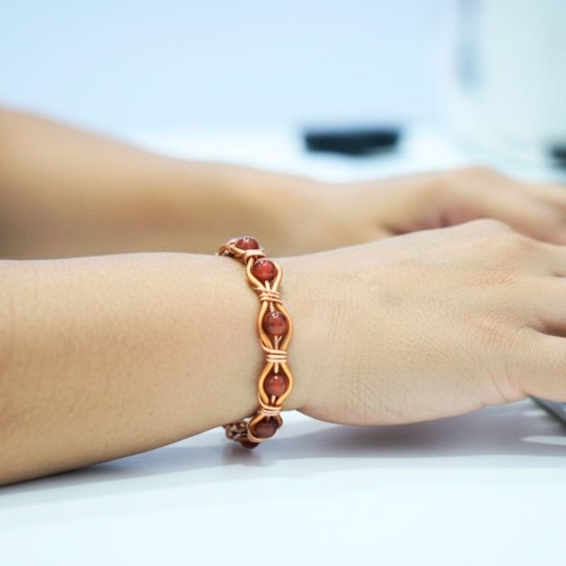 Radiant Twist Copper Bangle featuring Gemstones