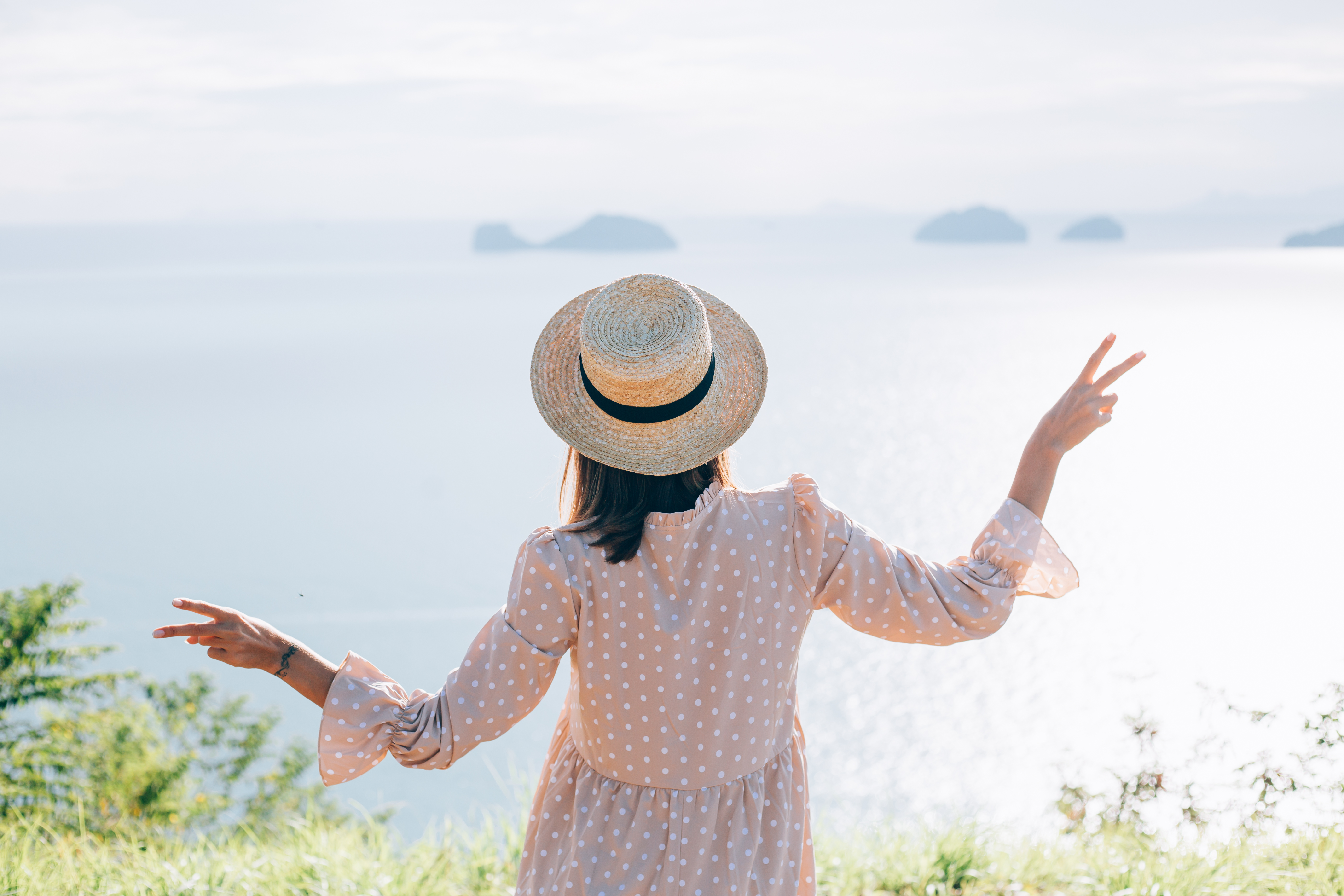 happy-woman-summer-cute-dress-straw-hat-vacation-with-tropical-exotic-views