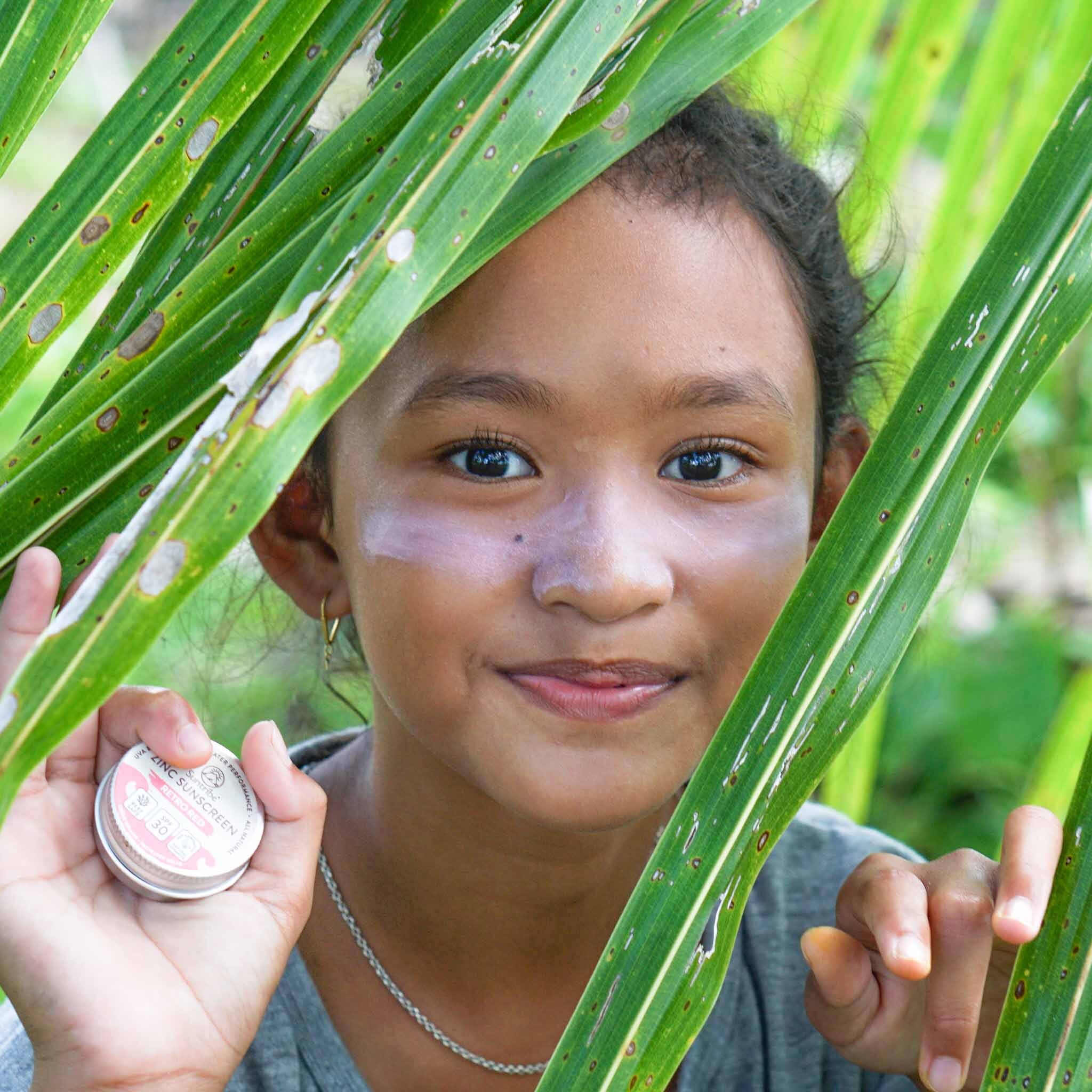 Zinc Pretty Pink - Girl smiling with tropical leaves indonesia - Suntribe Reef Safe Mineral Sunscreen @Marjos_Stories