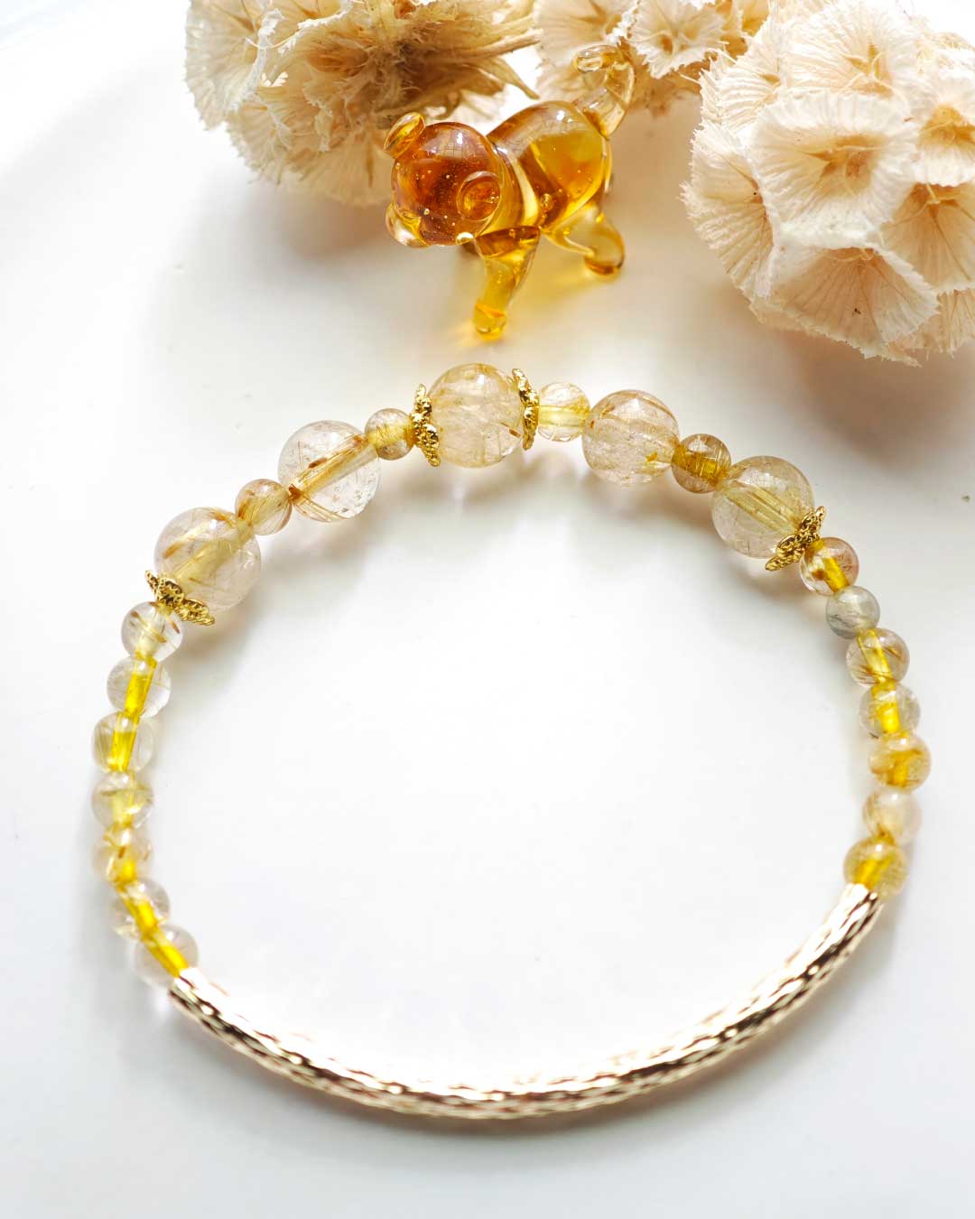 crystal-rutilated-quartz-braceletjpg 金色鈦晶圓珠搭配彎管設計的能量手鍊，展現時尚與財富氣場
