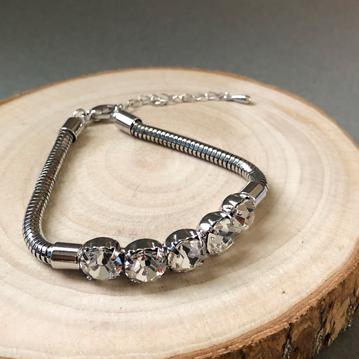 silver-crystal-stretch-bracelet-wood-background