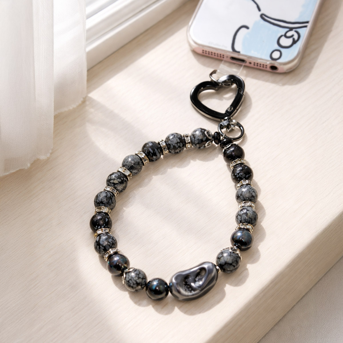 obsidian-snowflake-phone-strap-window-light