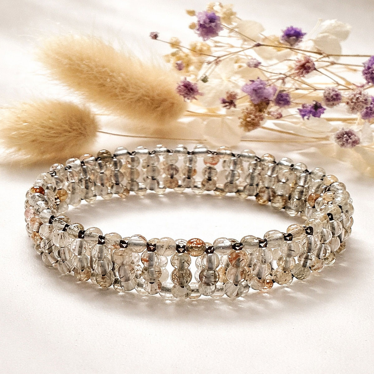 natural-obsidian-woven-bracelet-flatlay-dried-flowers