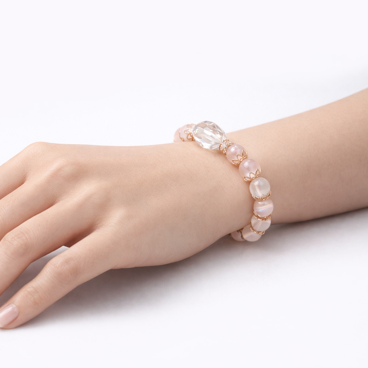 clear-quartz-rose-quartz-bracelet-on-hand