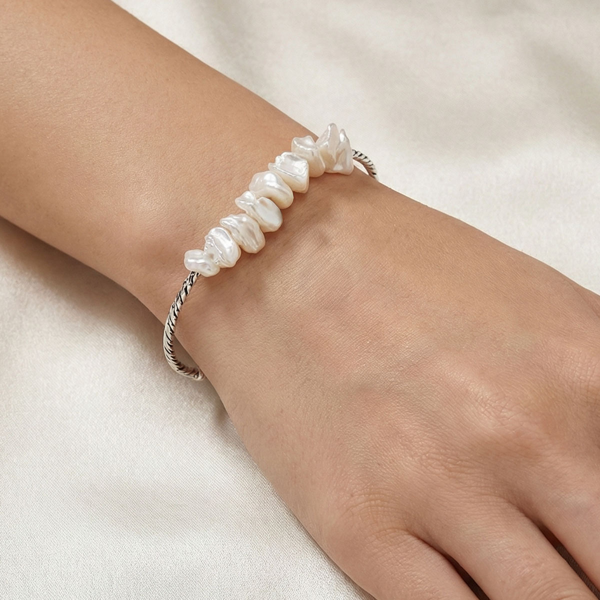 pearl-shell-silver-bangle-bracelet-worn-on-wrist