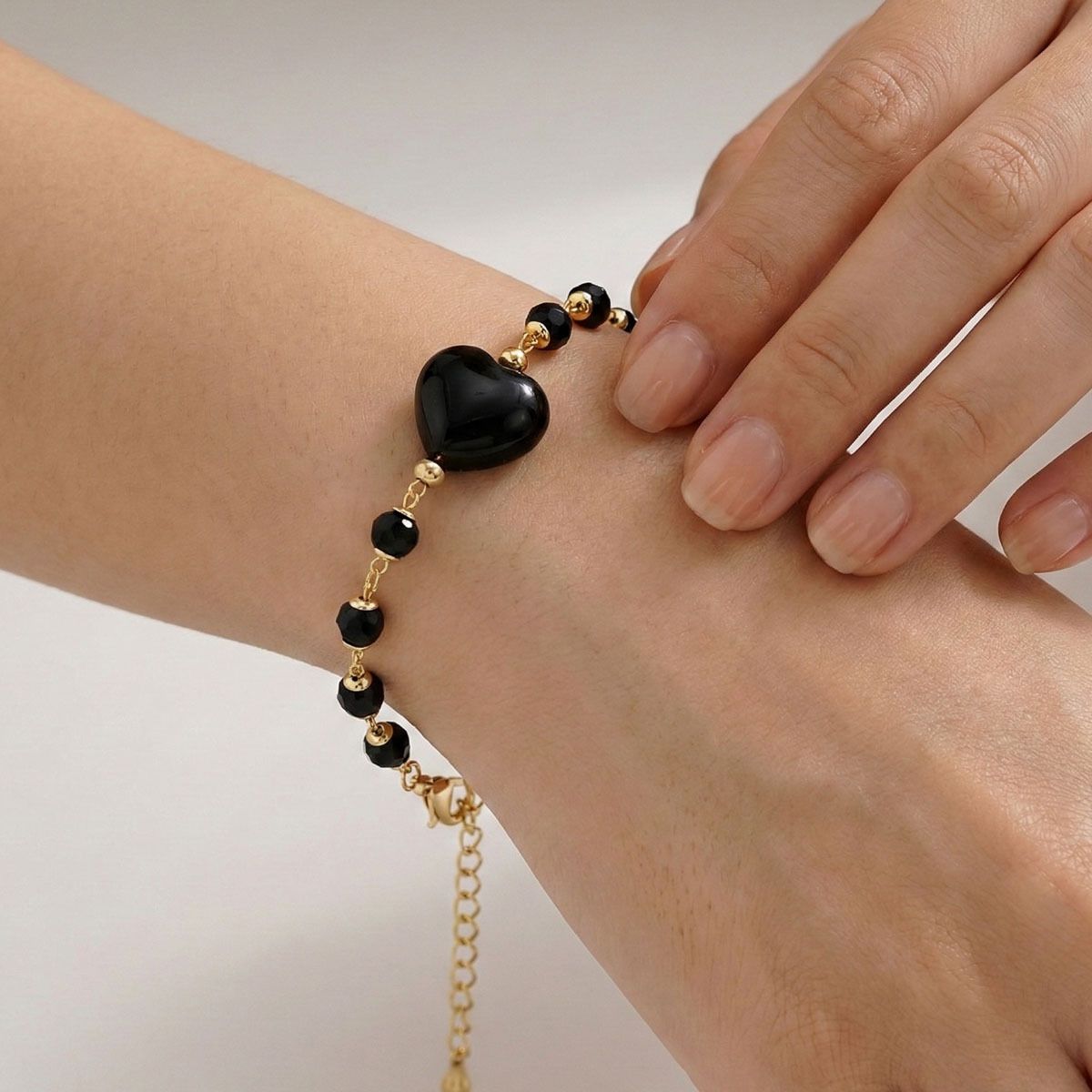 black-obsidian-heart-gold-bracelet-wrist-closeup