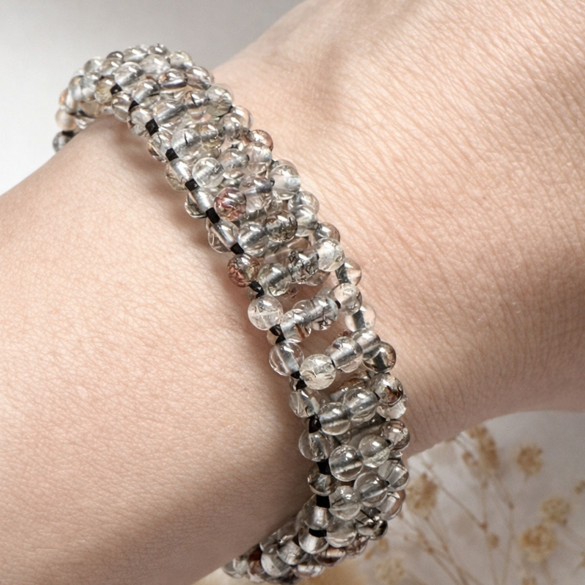 natural-obsidian-woven-bracelet-wrist-closeup