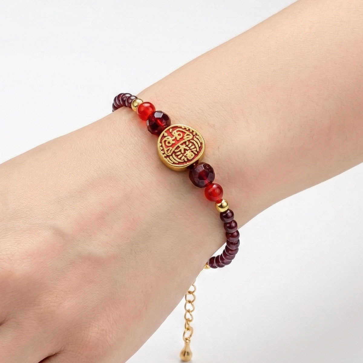 red-garnet-daruma-bracelet-worn-on-wrist