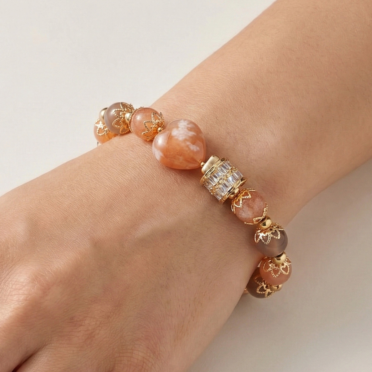 orange-moonstone-sakura-gold-bracelet-wearing-hand